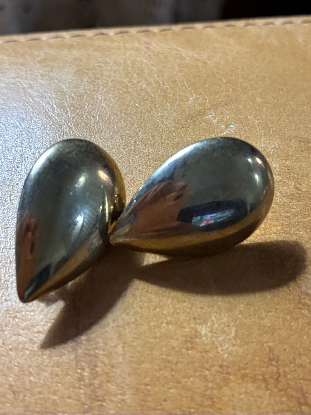 Lustrous gold tone Teardrop Clip-On Earrings. Slightly over 1 inch clips.